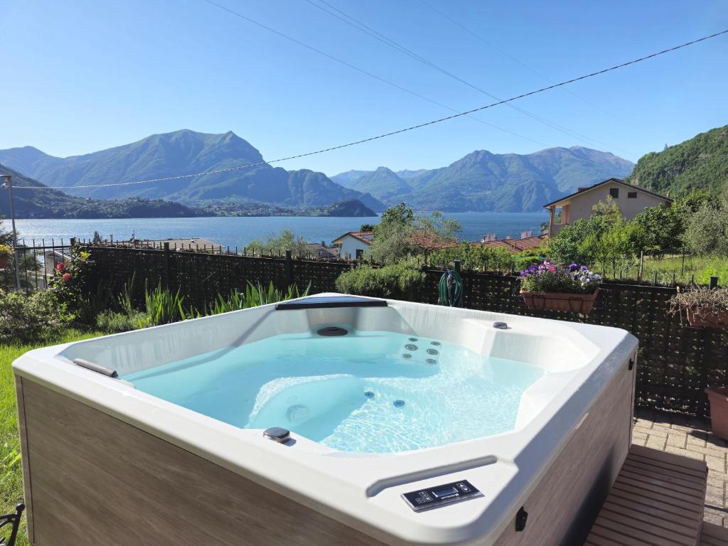 a hot tub on a patio with a view of a lake at Restorative stay Garden Jacuzzi Lake View in Lierna