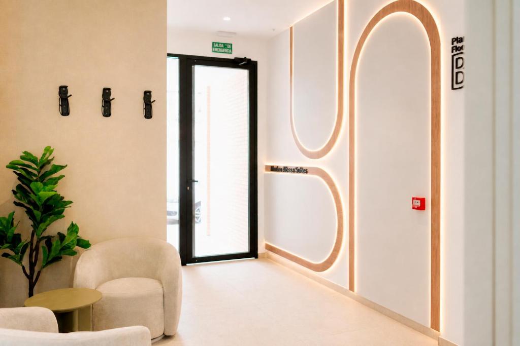 a hallway with a door and chairs and a table at SuiteStays Marino Albesa - Ayora, Valencia in Valencia
