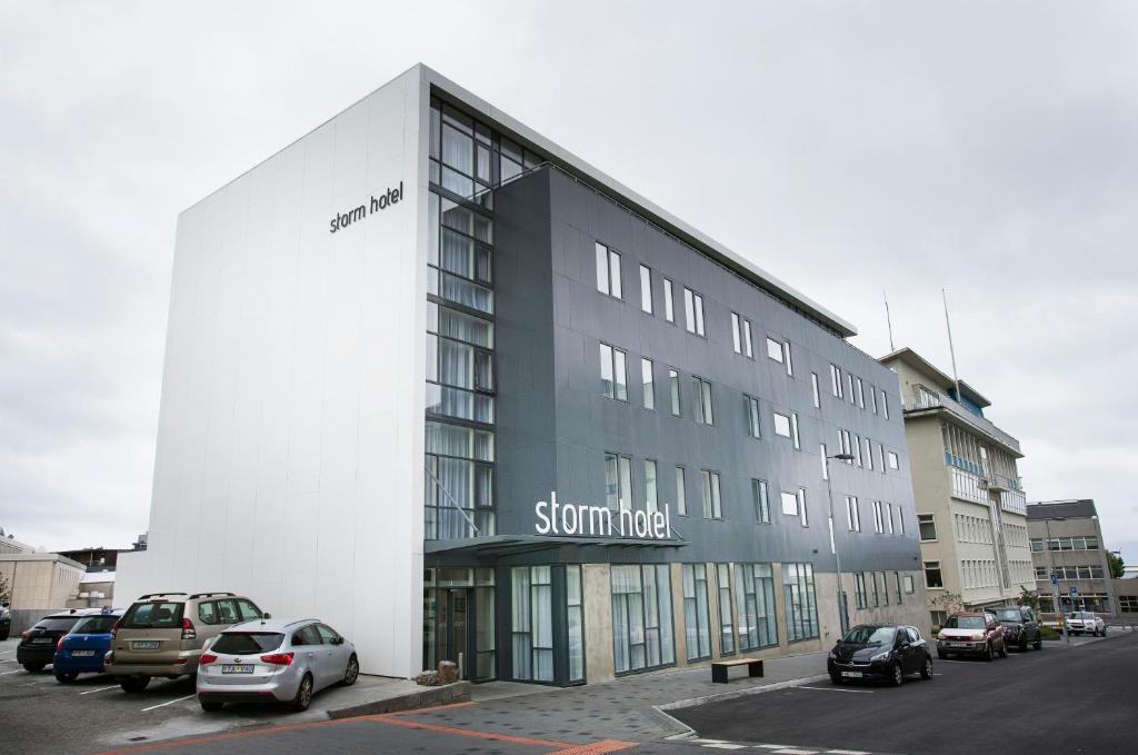 a large building with cars parked in a parking lot at Storm Hotel by Keahotels in Reykjavík