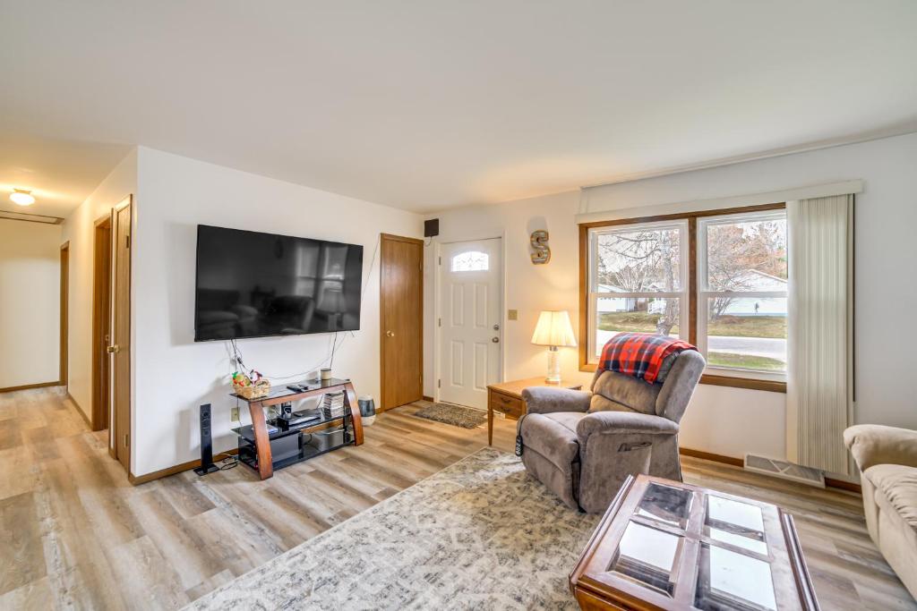 a living room with a couch and a tv at Explore the Upper Peninsula! Marquette Home in Marquette