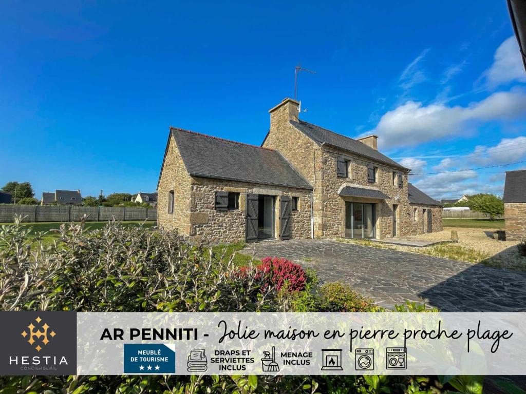 a stone house with a sign in front of it at AR PENNITI - Magnifique maison en pierre proche plage in Landéda