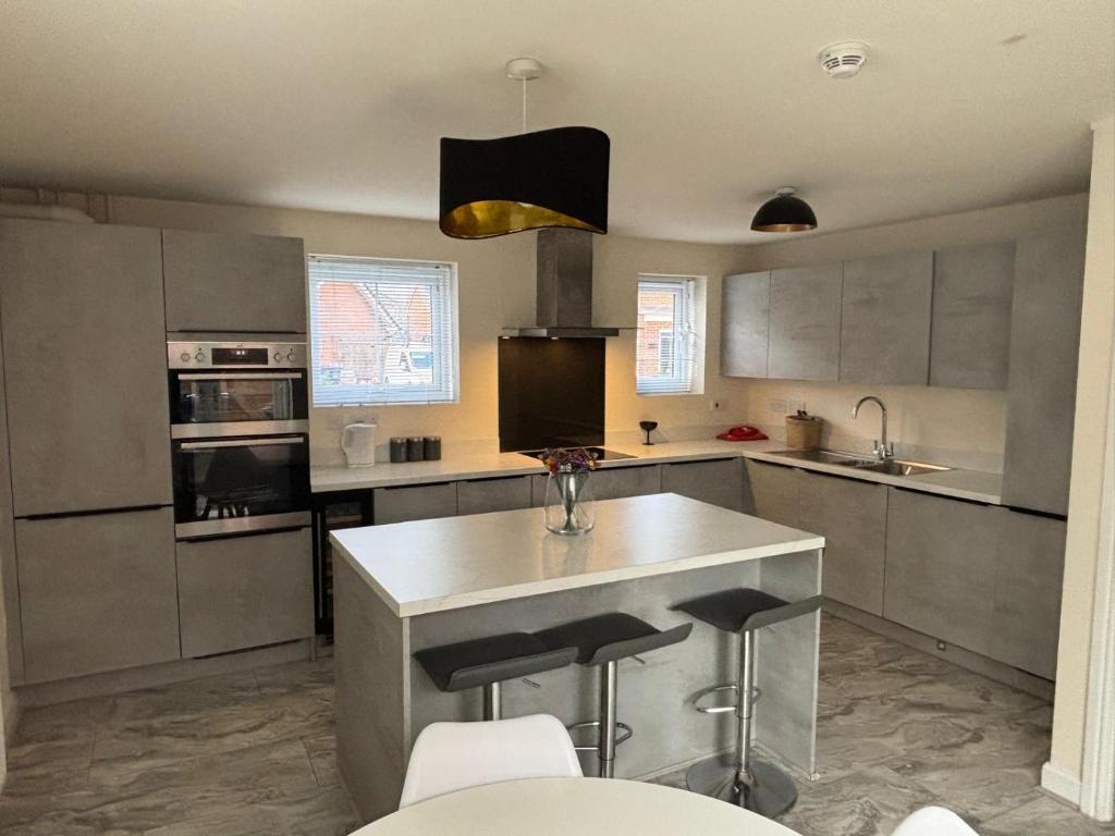 a kitchen with a island in the middle of it at Lion Gardens- The Space in Leyland