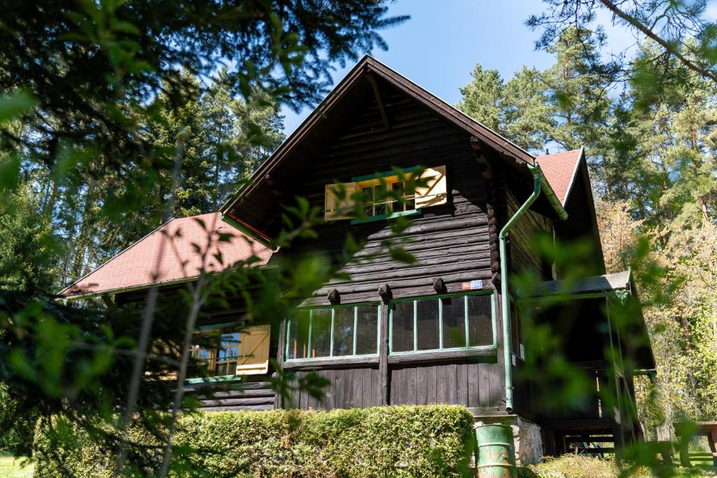 a small wooden cabin with a red roof at Špengel chata in Smižany