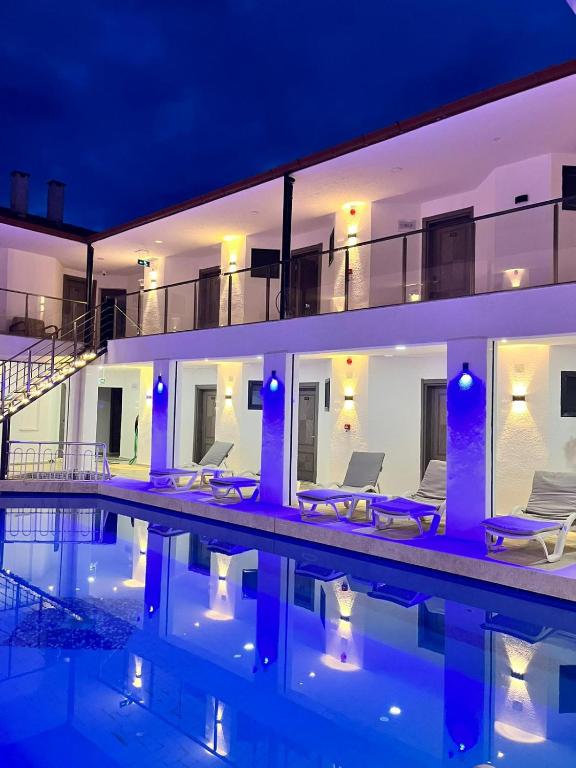 a villa with a swimming pool at night at Han Dalyan Hotel in Dalyan