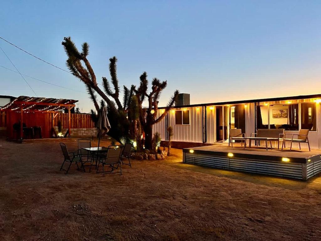a house with a table and chairs in front of it at Stargaze Grand Canyon in Meadview