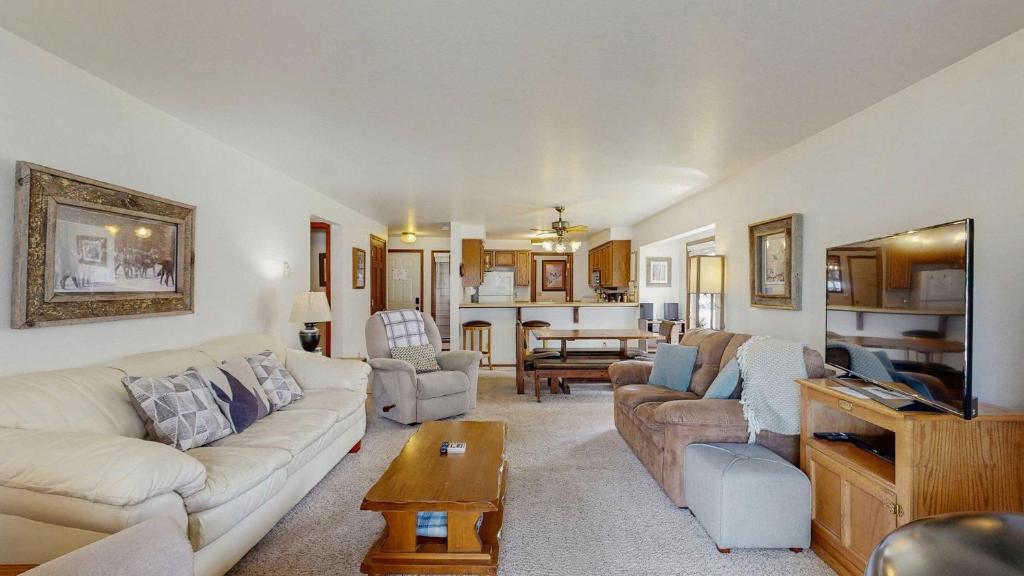 a living room with a couch and a table at Lake Town Access Deck Pool Wood Stove in McCall