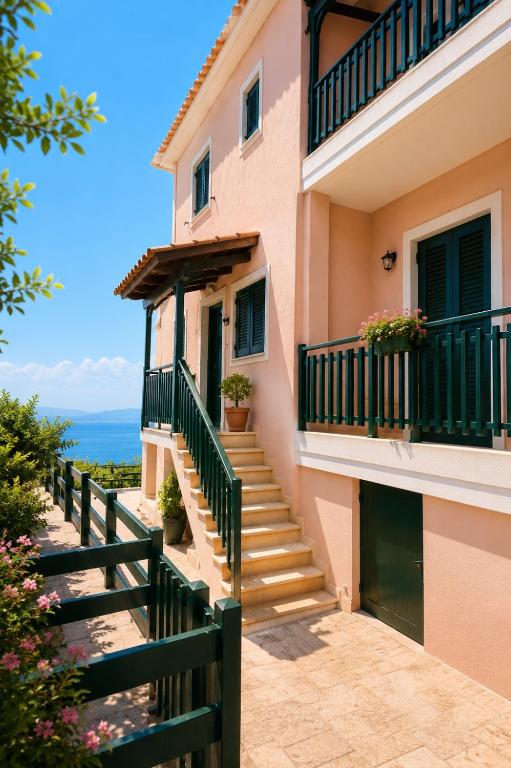 a building with stairs and balconies with the ocean in the background at Zen Villas in Nikiana