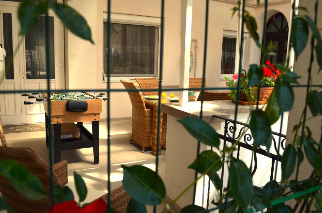 a balcony with a table and chairs in a room at Demjén ház in Nyíregyháza