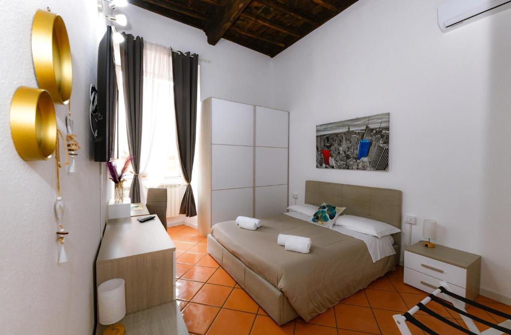 a bedroom with a bed and a mirror in it at Dimora Cavour 1810 in Civitavecchia