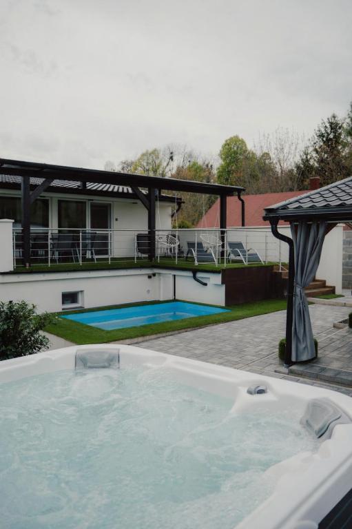 a hot tub on the patio of a house at Time to Relax in Zalakaros