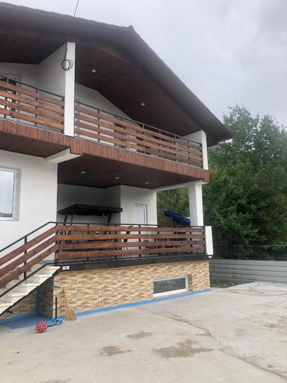 a building with wooden balconies on the side of it at ALEXS house in Sadgeri