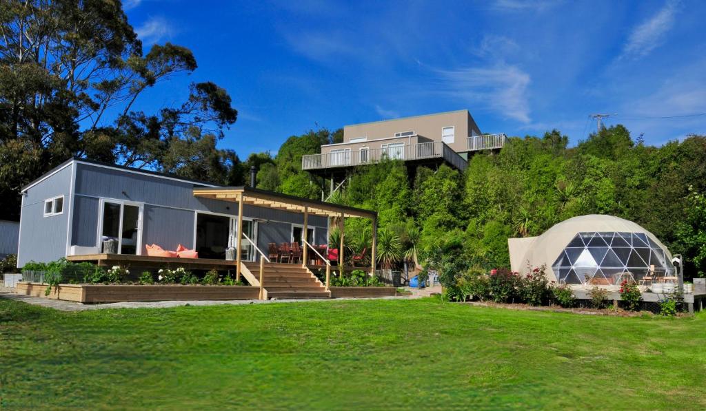 a house on top of a hill with a yard at Diana's Place in Moeraki