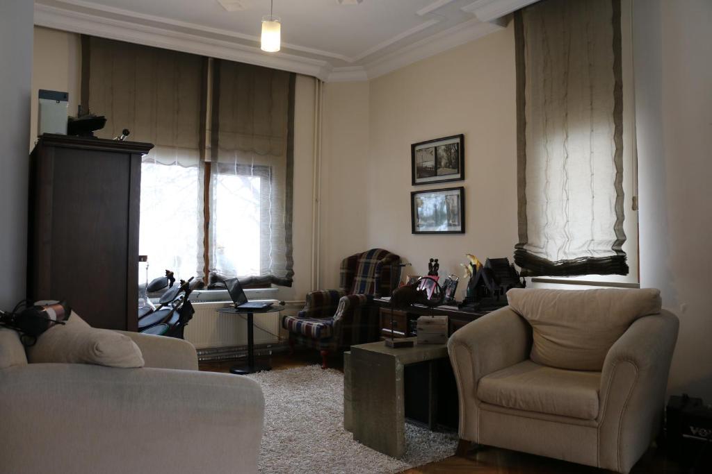 a living room with a couch and chairs and a window at Best Room in Town in Karakusunlar Köyü