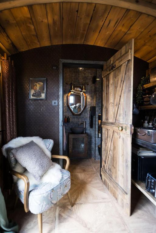 a room with a chair and a wooden door at The 450 from Paddington in Bourton on Dunsmore