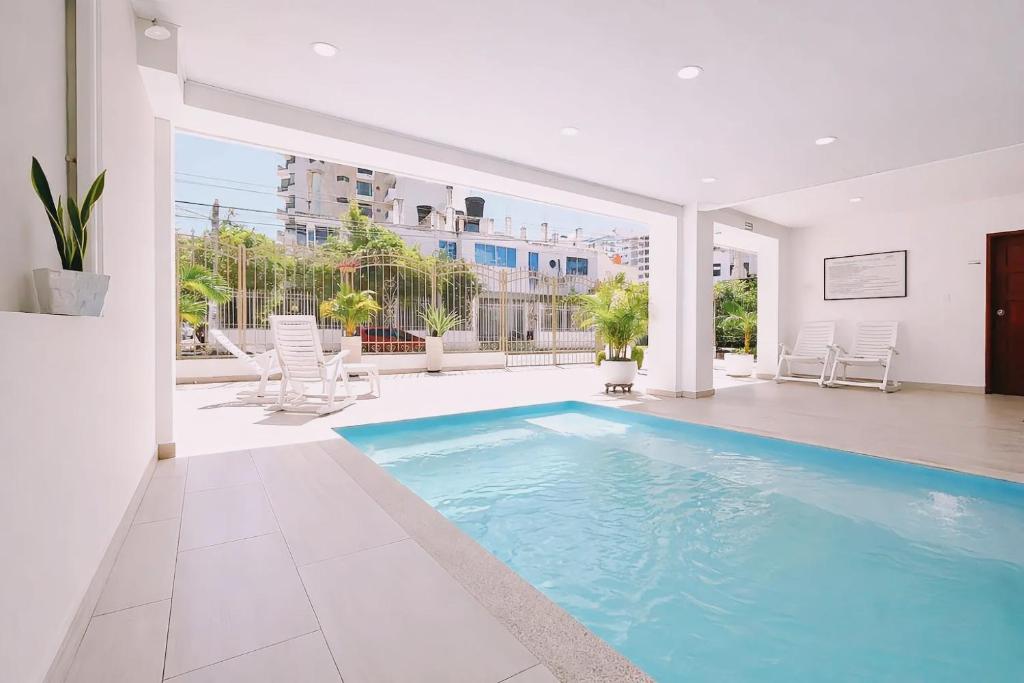 a swimming pool in the middle of a house at Delfin Hotel Collection Rodadero in Rodadero