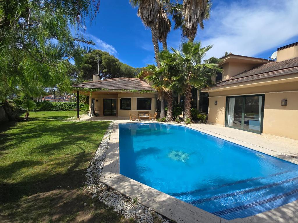 a swimming pool in the yard of a house at Villa Terramar by Hello Homes Sitges in Sitges