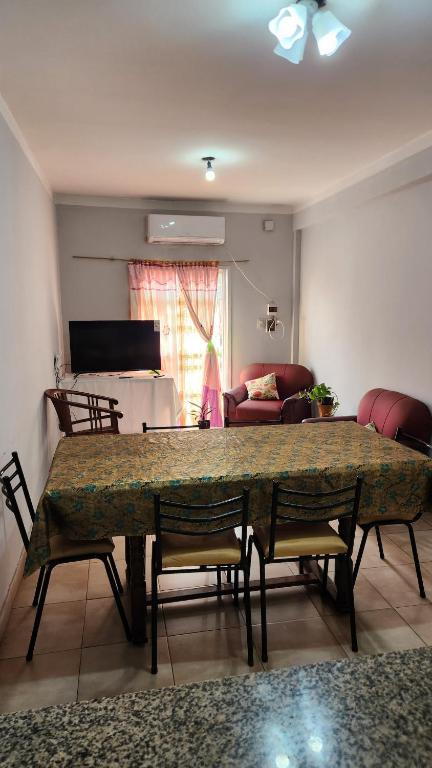 a living room with a large table and chairs at Depto rep del libano 11 capacidad 5 personas in La Banda