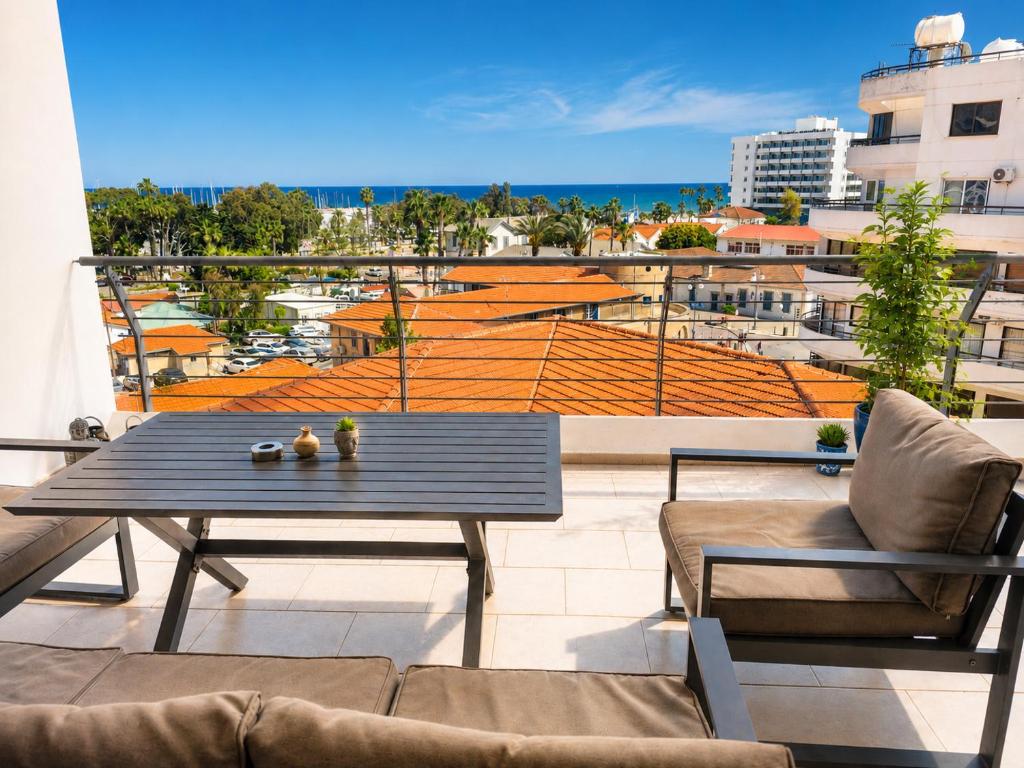 a patio with a table and chairs on a balcony at Best Seaview in Larnaca - 2 BDR Apt - 2 Min Walk to Beach in Larnaca