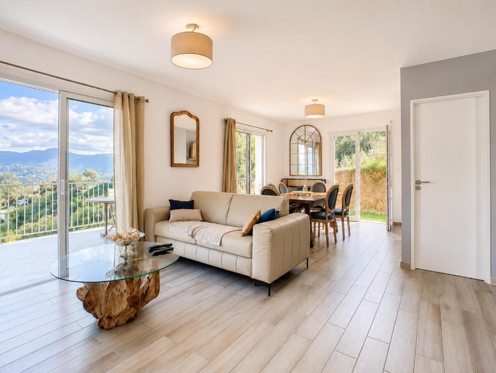 a living room with a couch and a table at Villa Muvra in Ajaccio