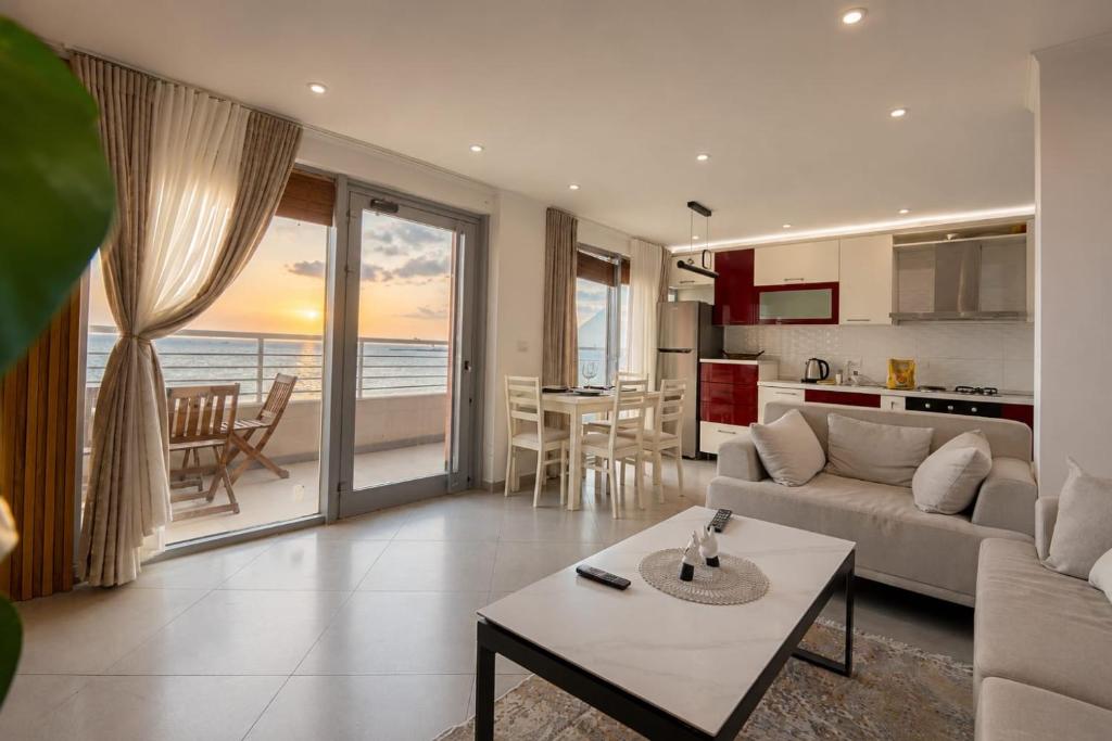 a living room with a couch and a table at Luxury sea view duplex in Durrës