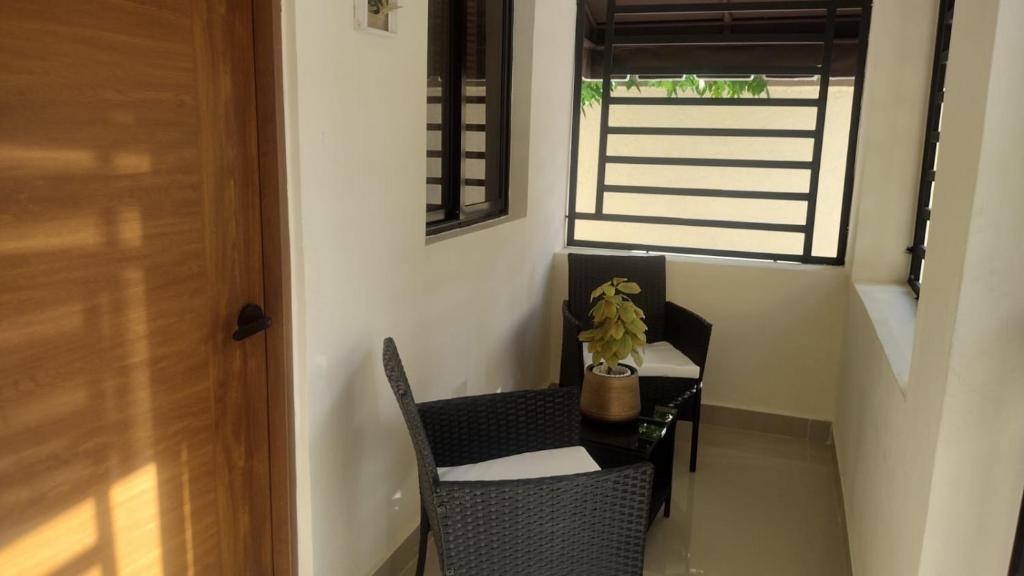 a small table and chairs in a room with a window at Johanna 1 in Los Tres Ojos de Agua