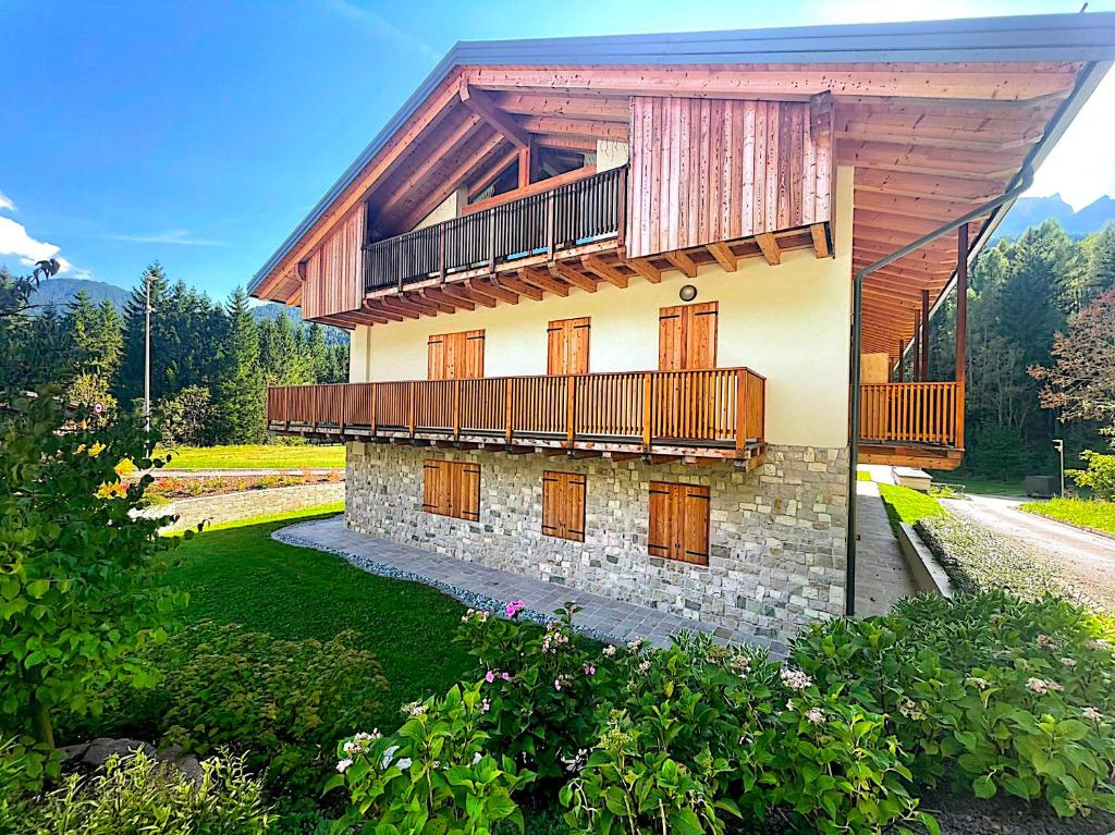 a building with a balcony on top of it at Alpine Heaven in Borca di Cadore