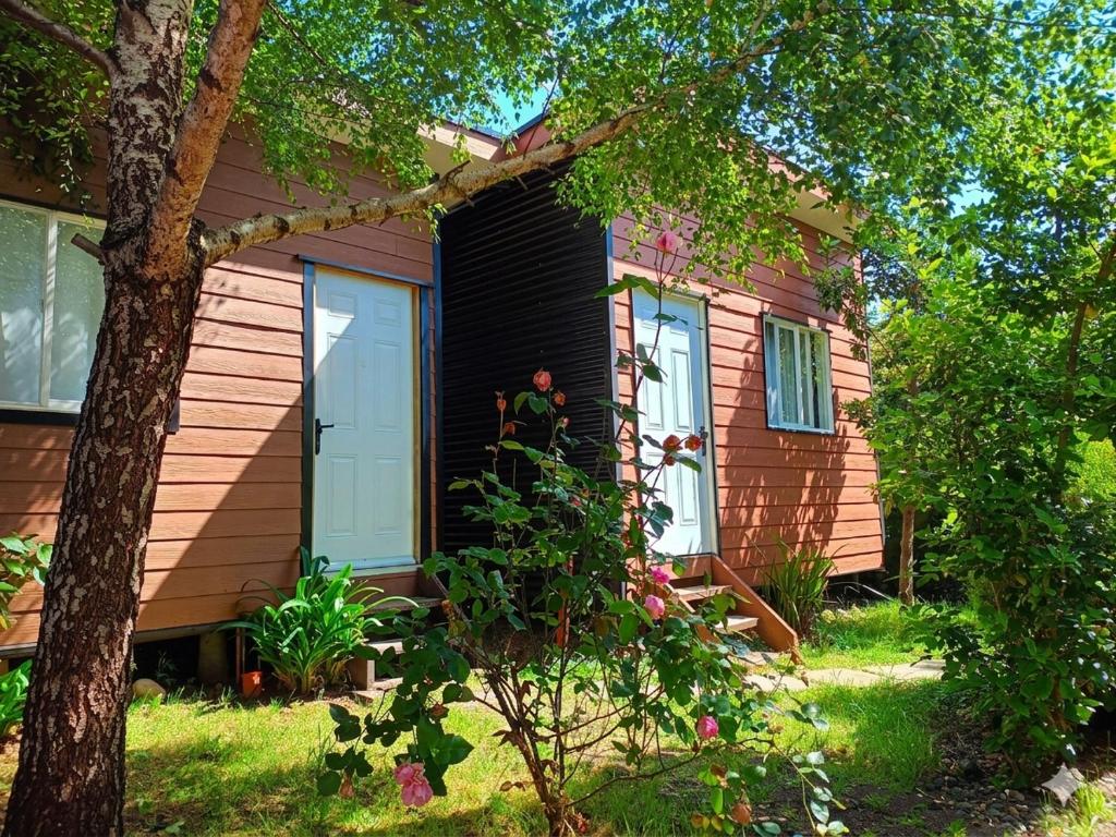 a house with a person standing outside of it at Borde Lago IV - V in Puerto Varas