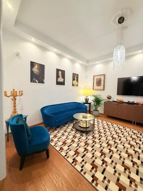 a living room with a blue couch and a tv at Villa Chamare in Pero
