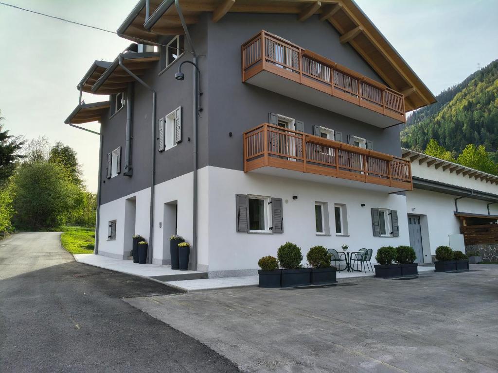 a building with two balconies on the side of it at Casa Nadia - Val di Sole Apartment in Piano