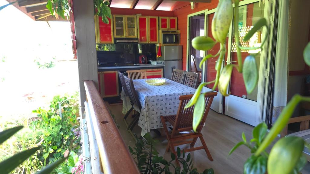 a kitchen with a table and chairs on a balcony at Kay Lydie in Saint-Joseph