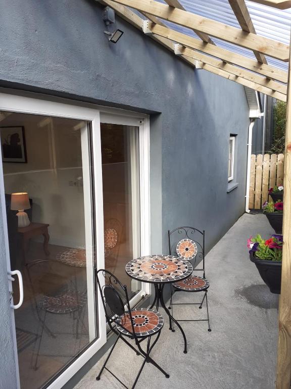 a patio with a table and chairs on a patio at The Lodge in Galway