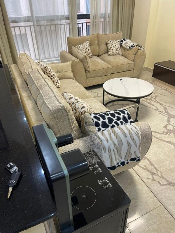 a living room with a couch and a table at Kaisa garden in Nairobi
