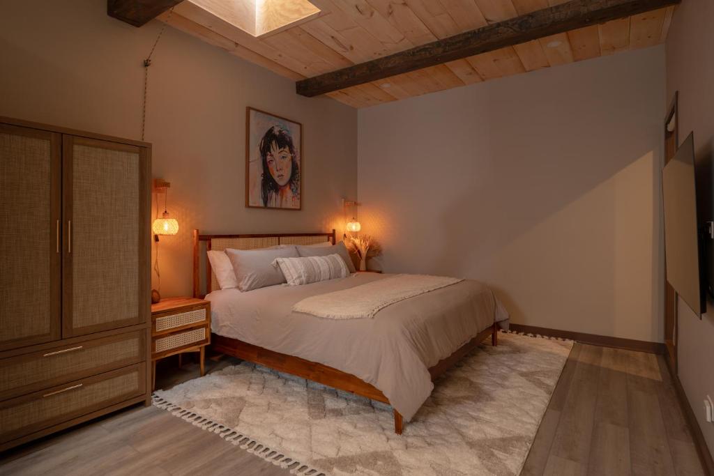 a bedroom with a bed and a painting on the wall at Pulaski Point Properties in Chicago
