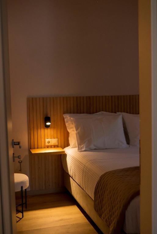 a bedroom with a bed and a night stand with a lamp at Jo's Apartment in Mytilene