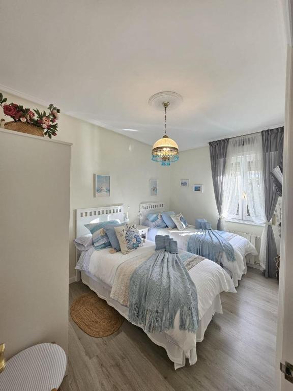 a bedroom with two beds with blue pillows at A un paso de Bilbao in Galdakao