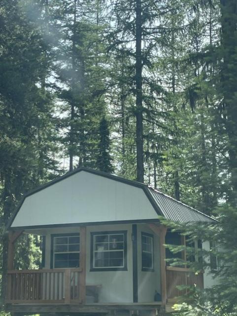 a small cabin with snow on top of it at Glacier Haven Inn in Pinnacle