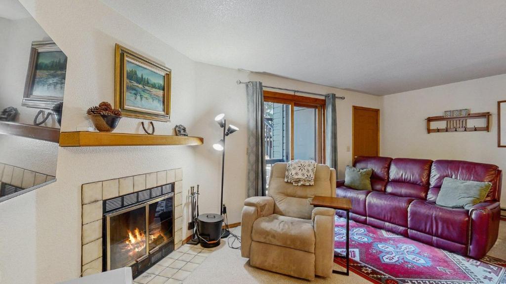 a living room with a couch and a fireplace at Downtown McCall Condo with Balcony & Views in McCall