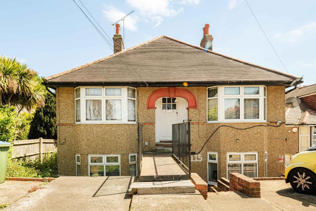 a brick house with a white door at Swingate Lane Stay in Plumstead