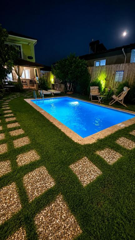a swimming pool in the yard of a house at night at Villa Dalaman Müjgan Hanım Konağı in Dalaman