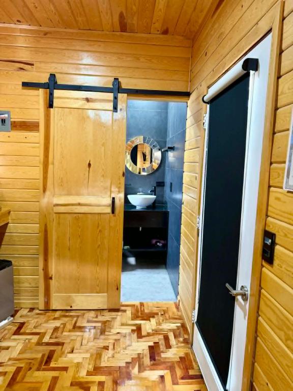 a bathroom with a wooden door and a sink at Caminante in Creel