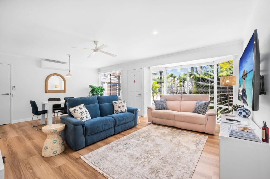 a living room with a couch and a table at Renovated 2 Bedroom Ground Level Villa in Noosaville in Noosaville
