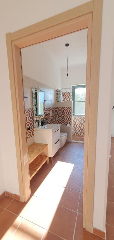 a bathroom with a toilet and a sink at Piccolo Paradiso Crotone in Casa Margherita