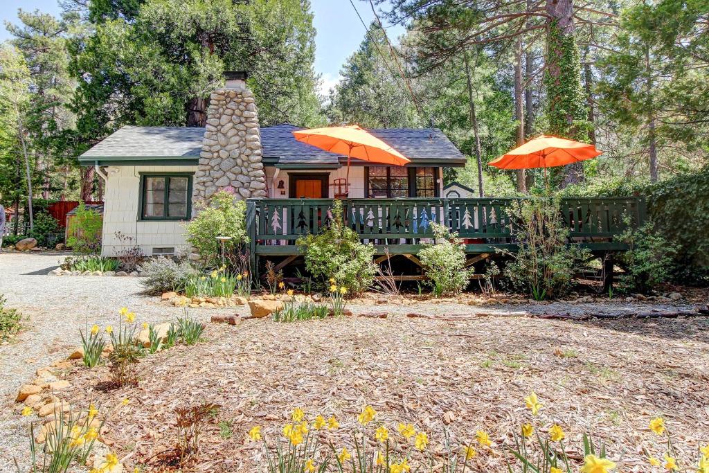 a house with a deck and two umbrellas at The Crow's Nest in Idyllwild