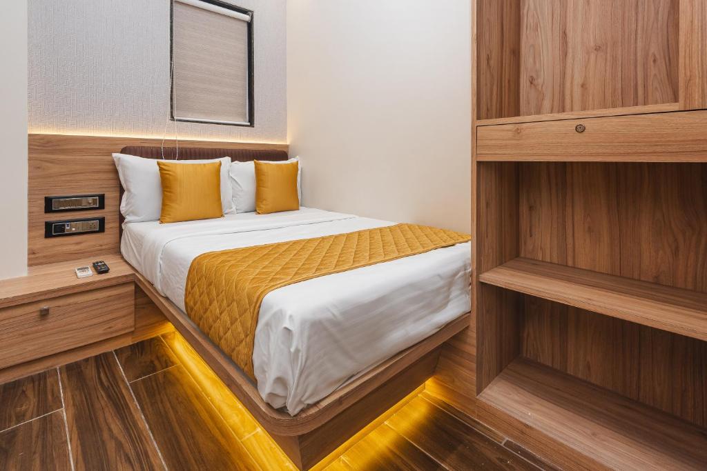 a bedroom with a bed in a small room at Hotel Lexus7 in Mumbai