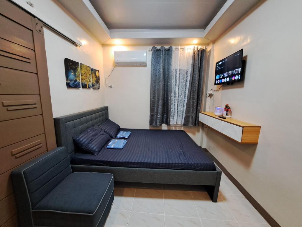 a small room with a bed and a chair at Seaview Transient House in Bucayao