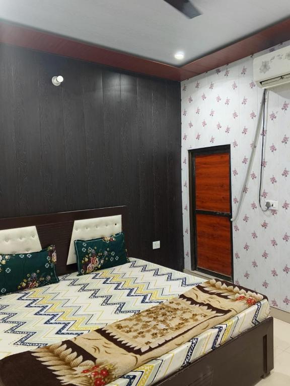 a bedroom with a large bed in a room at Hotel Shree Sanwaliya INN in Ayodhya