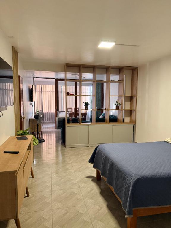 a bedroom with a bed and a living room at Departamento Ebenezer in Matarani