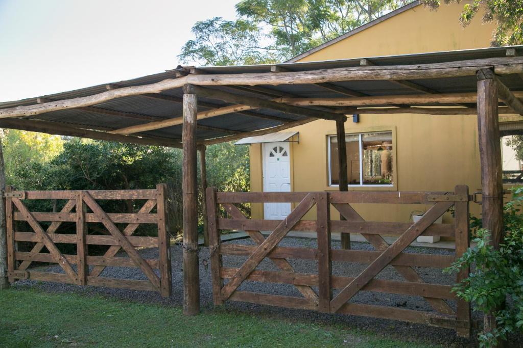 a wooden gate and fence in front of a house at El Solar in Vuelta de Obligado
