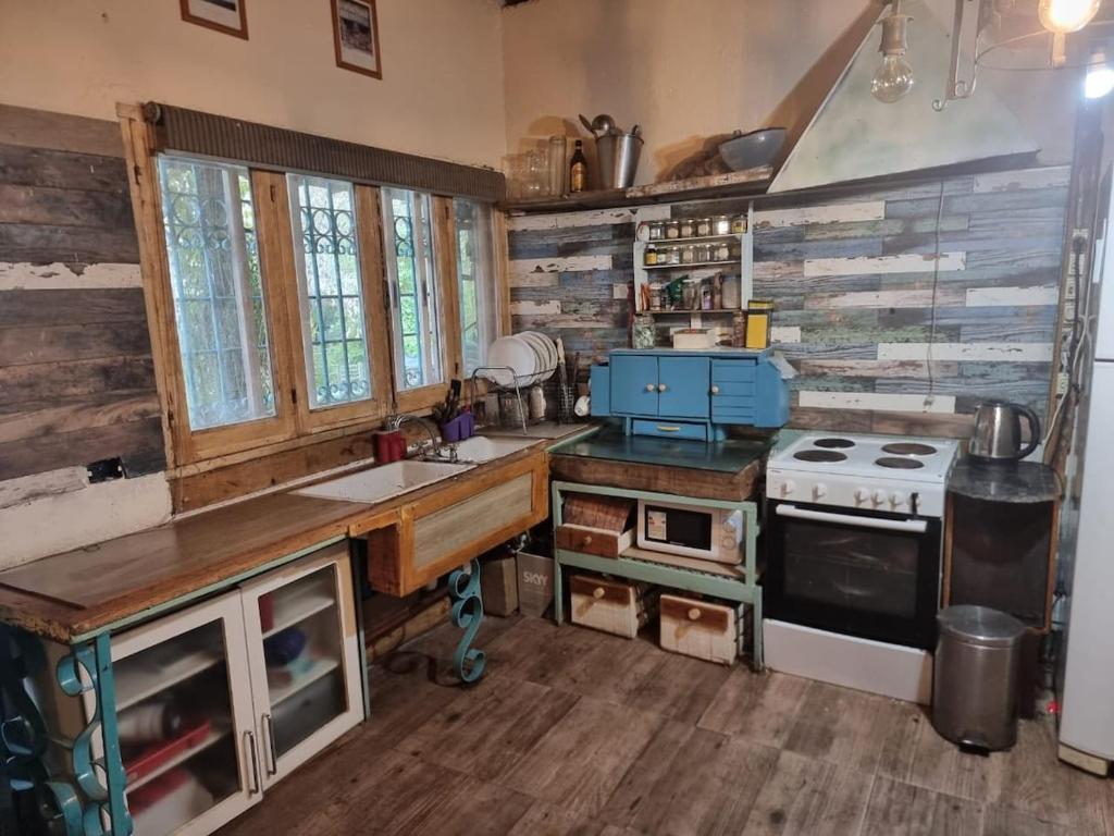 a kitchen with a sink and a stove at Mountain House with Wonderful View in Las Compuertas
