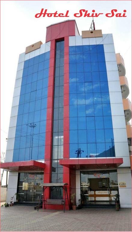 a large building with blue and red glass at Hotel Shiv Sai in Shirdi